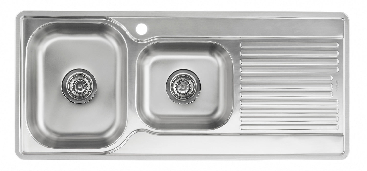 Stainless steel kitchen sink with a drainboard on a white background