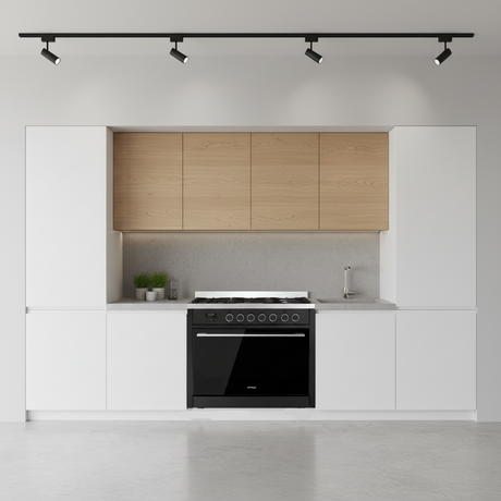 Black kitchen stove with digital display and control knobs on a white background